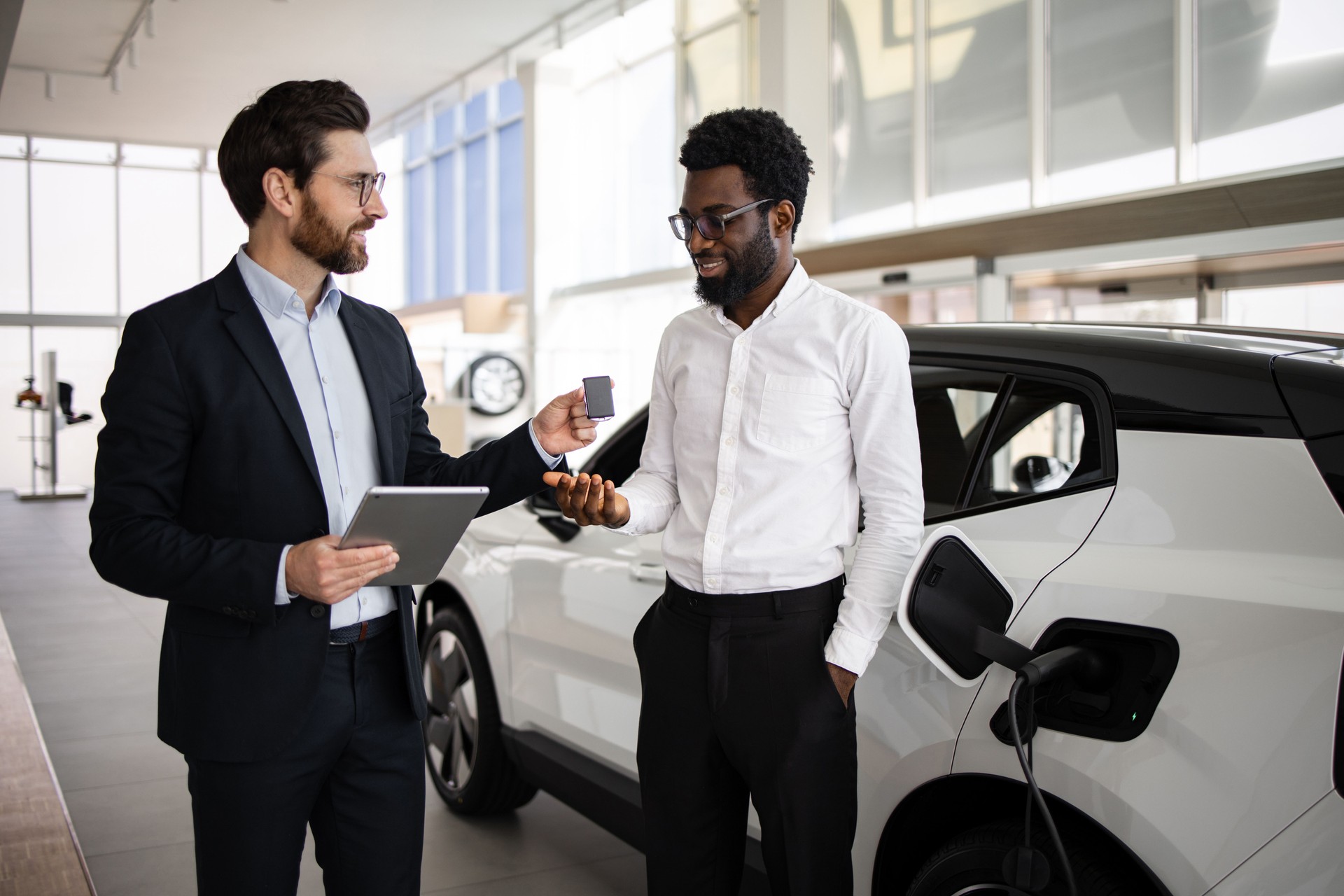 Dealer sells electric SUV to businessman in car dealership